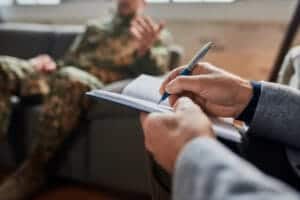 Therapist takes notes while talking to client as they start a benzodiazepine addiction treatment program