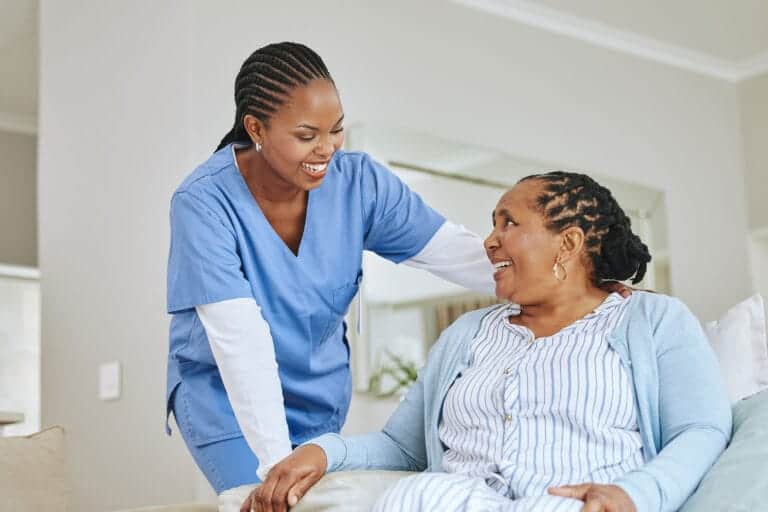 Nurse smiles while talking to client in a PHP in Chandler, AZ