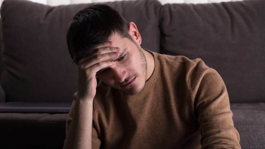 Seasonal Affective Disorder in Arizona Substance Abuse Sad Man in Front of Sofa